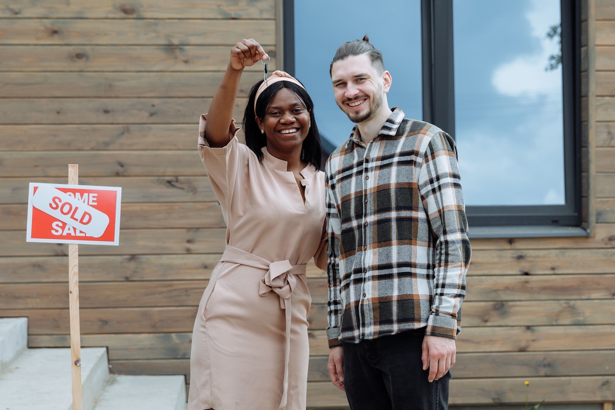 First-time buyers holding the keys to their new home